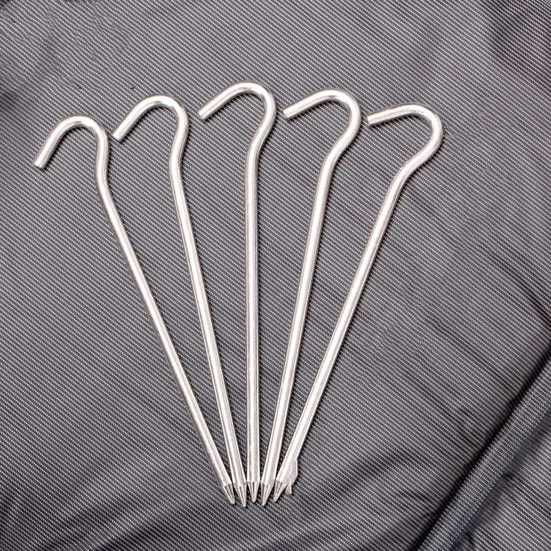 tent windproof ground nail set of five silver high-strength aluminum pins with hooked tops on textured gray fabric